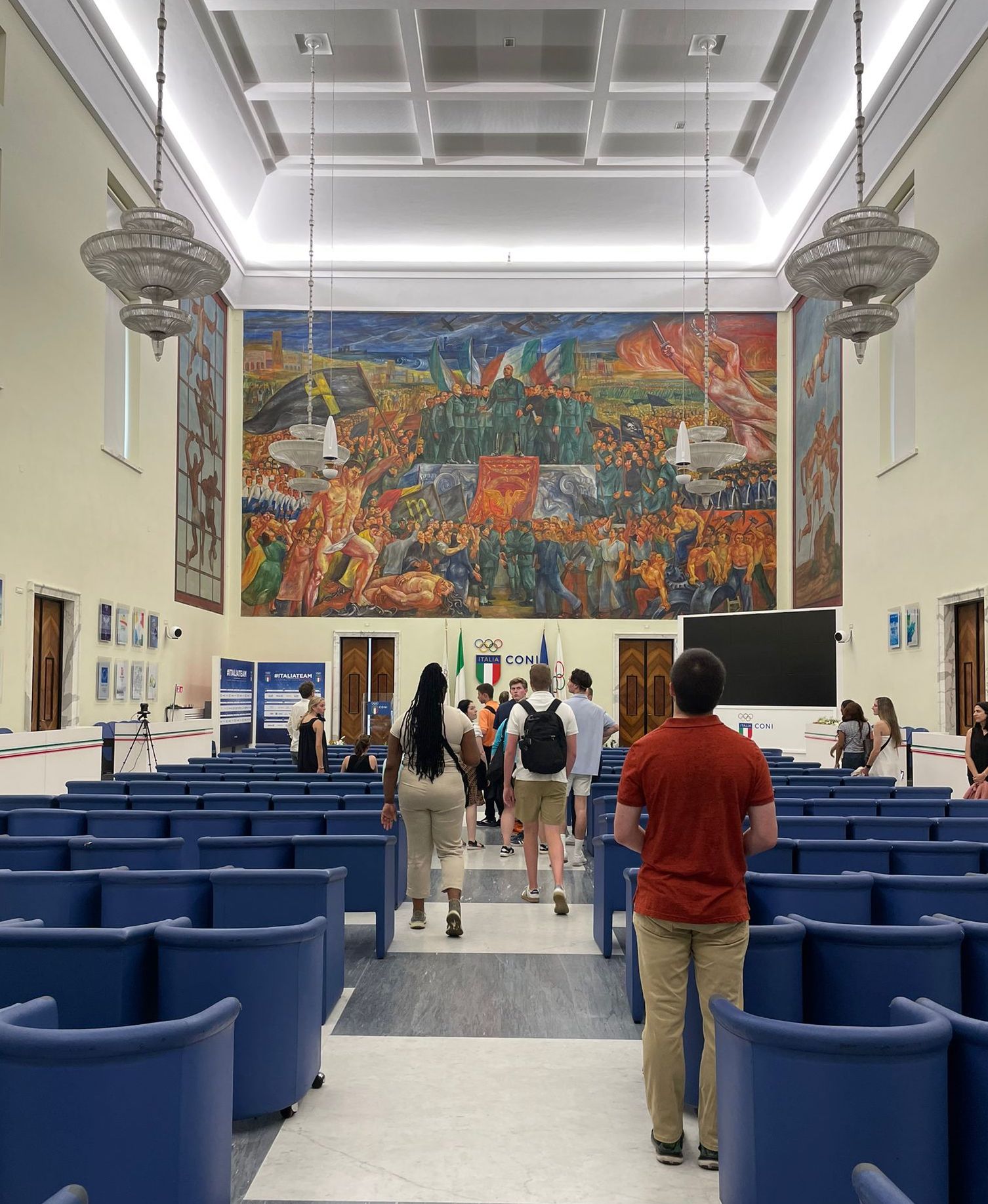 students enter mosaic-decorated swimming pools and the main representative room, in which official CONI press conferences take place